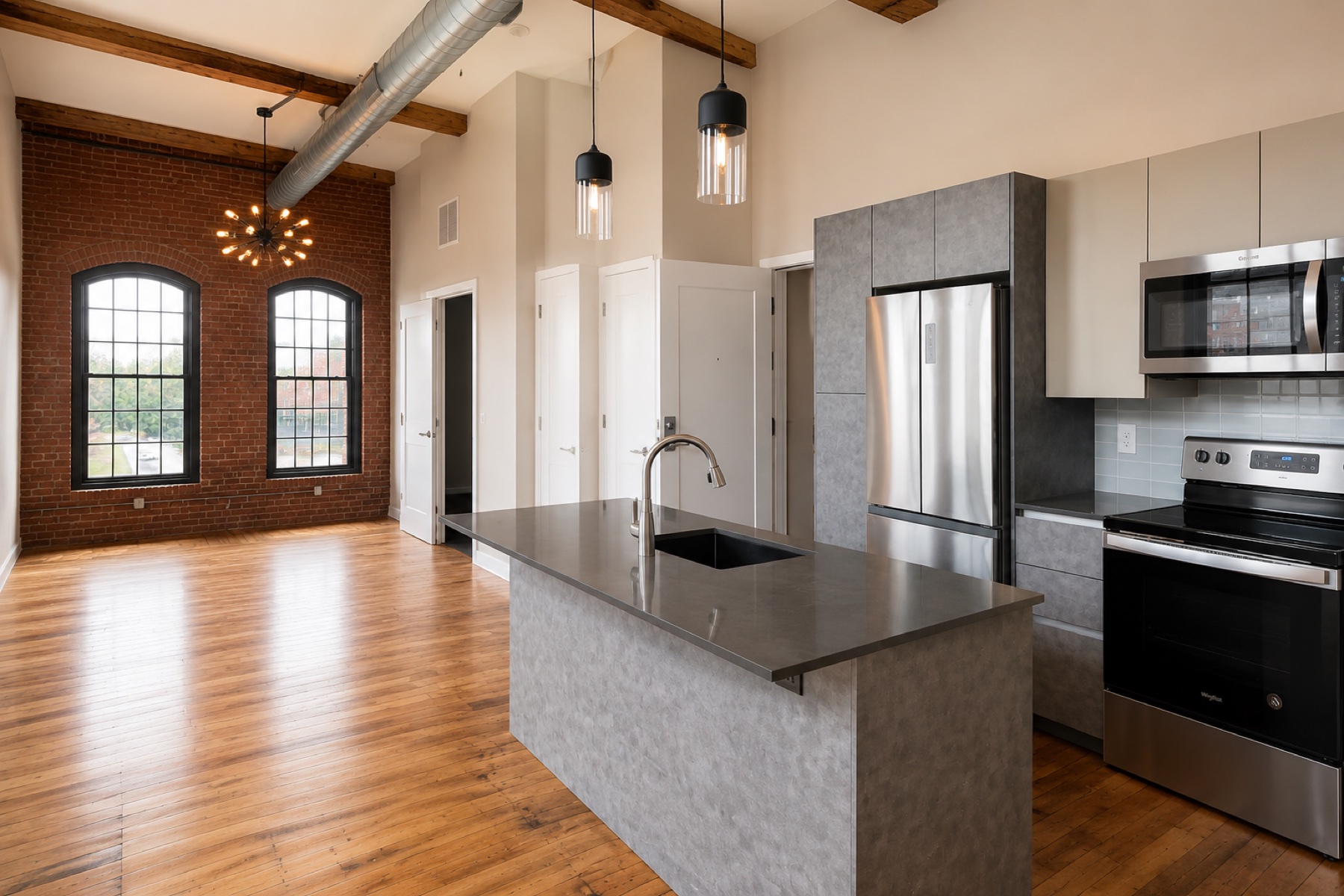 Loft kitchen framed by original brick and timber