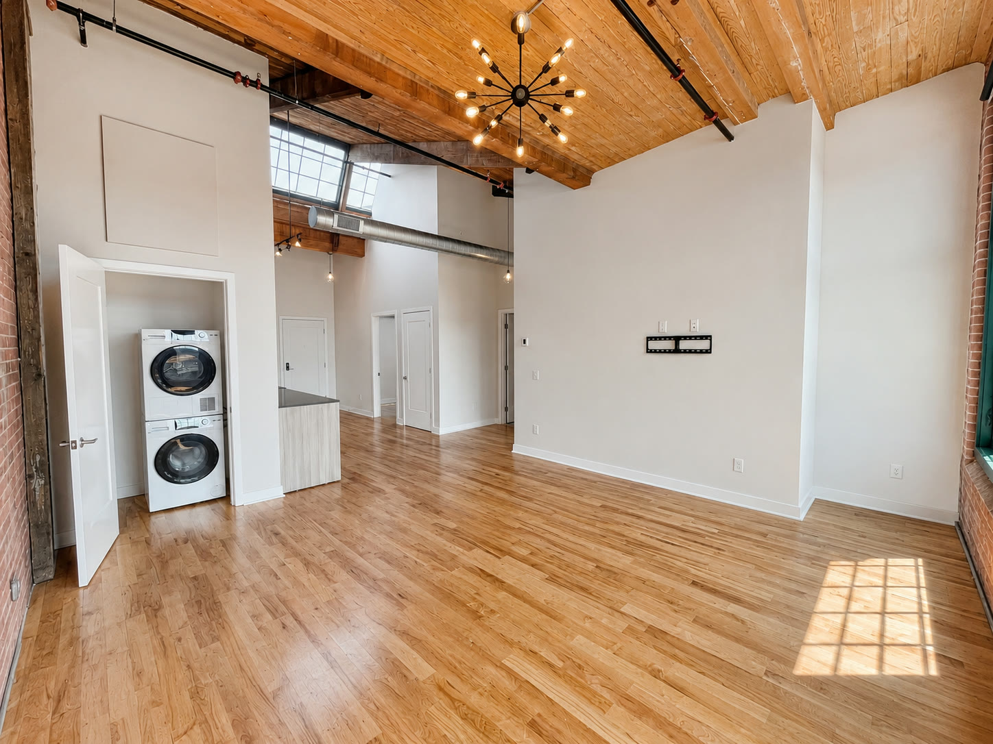 Living room at Roosevelt Mill with sputnik light and mill windows