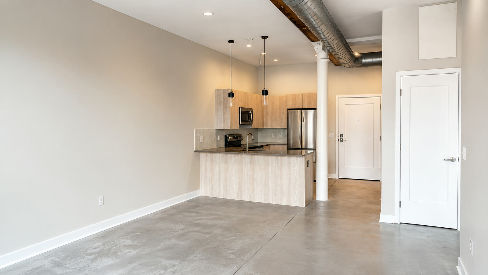 Loft kitchen at Wanskuck Mill, morning sun on polished concrete
